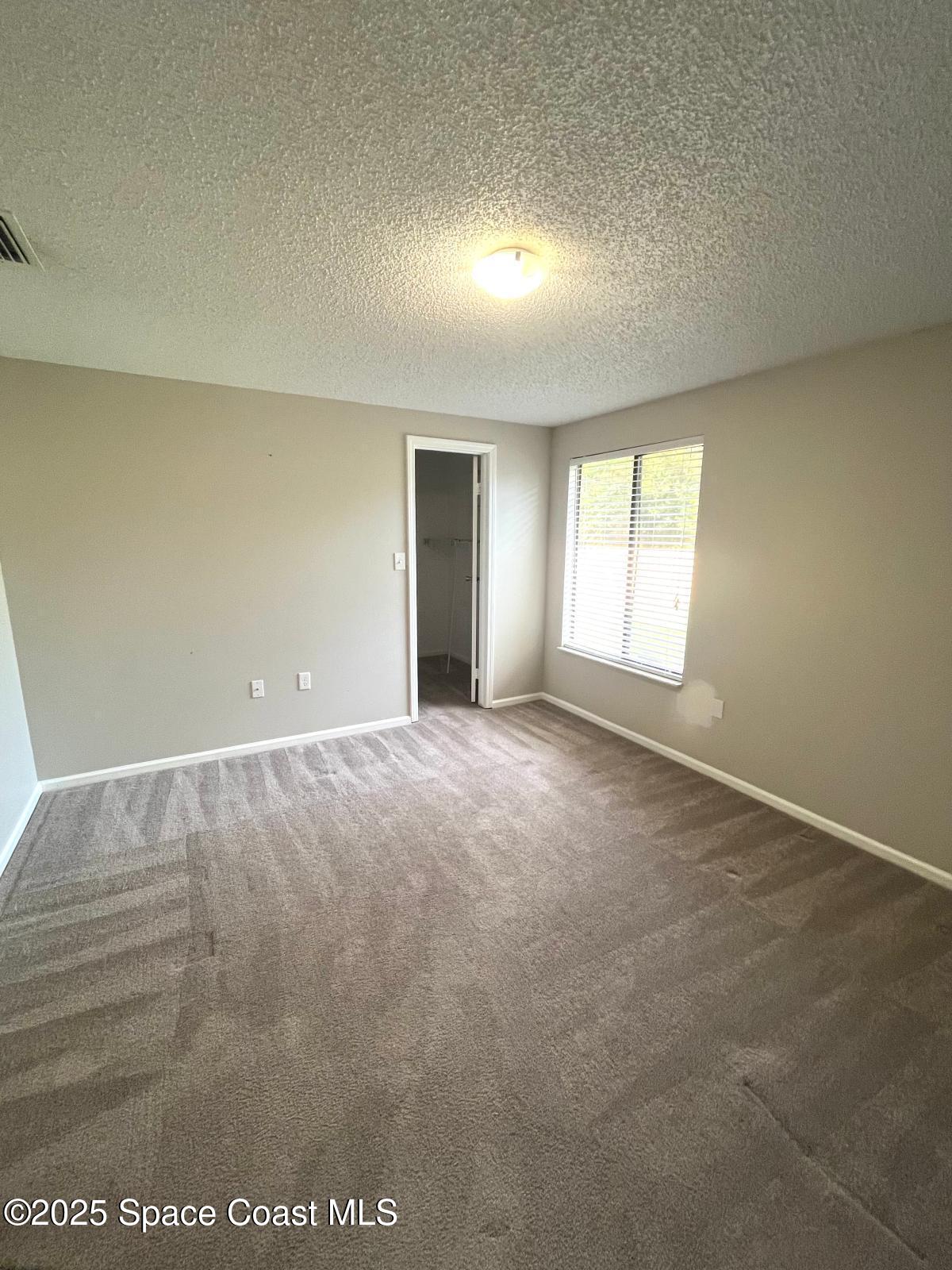 1626 Lara Street Northeast Palm Bay, FL 32907 - Photo 7 of 11 an empty room with windows