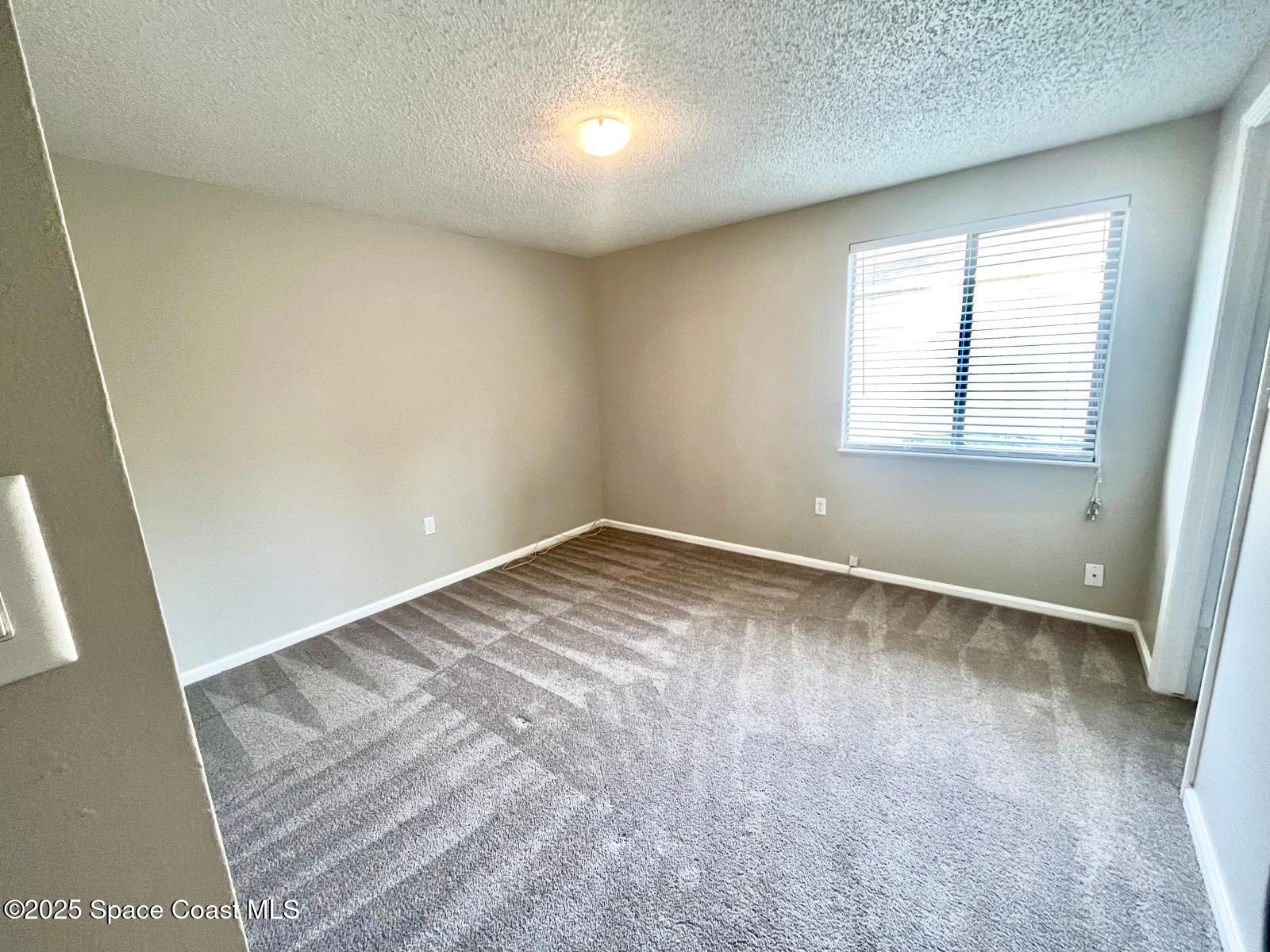 1626 Lara Street Northeast Palm Bay, FL 32907 - Photo 8 of 11 an empty room with a window