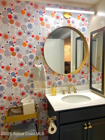 a bathroom with a sink mirror and vanity