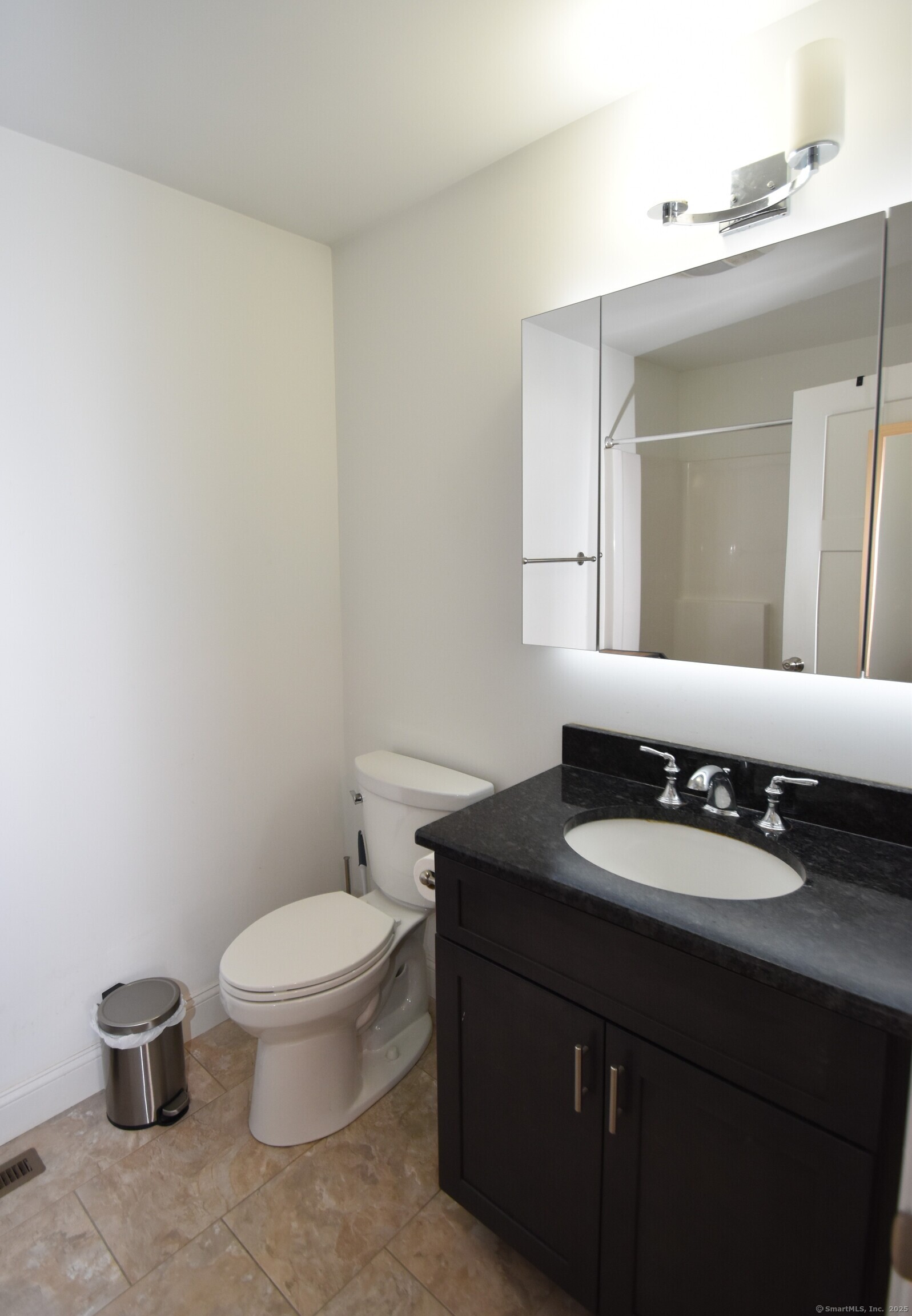501 Old Village Circle Windsor, CT 06095 - Photo 11 of 16 a bathroom with a granite countertop toilet sink and mirror