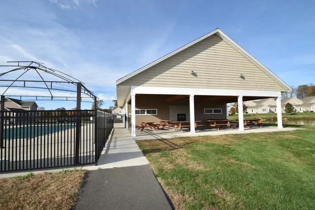 a view of a house with backyard and porch