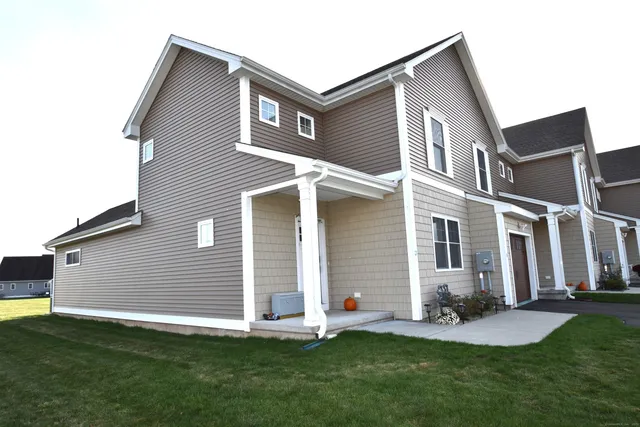 a backyard of a house with table and chairs