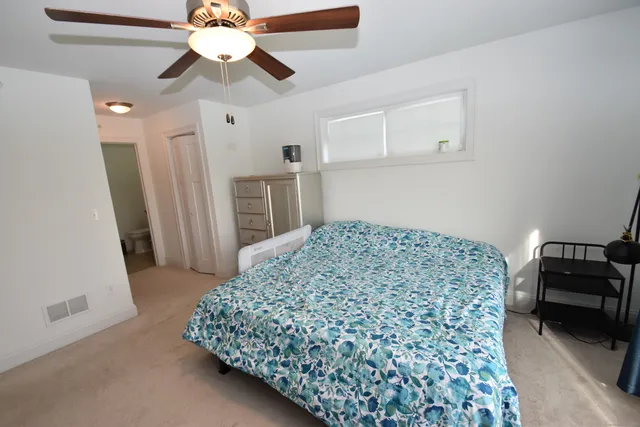 a bedroom with a bed and a couch