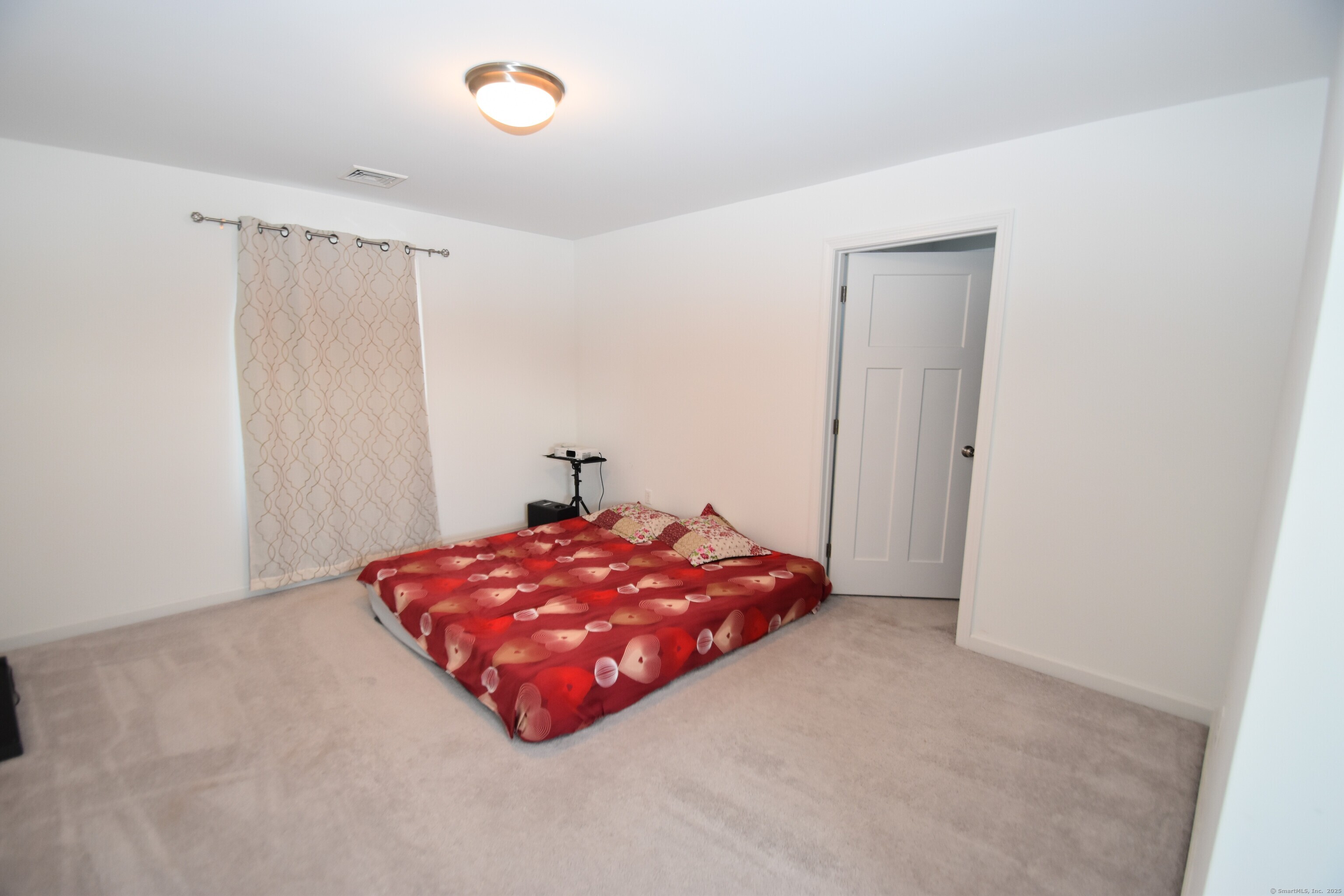 501 Old Village Circle Windsor, CT 06095 - Photo 9 of 16 a room with a bed and a window