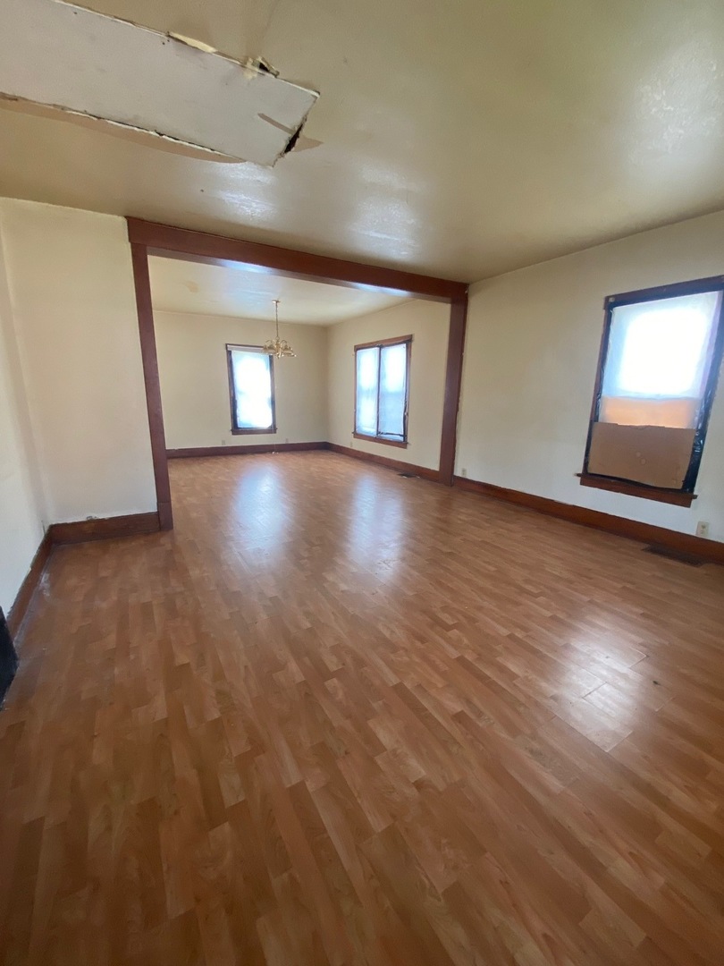 330 West Everett Street Dixon, IL 61021 - Photo 11 of 34 an empty room with wooden floor and windows