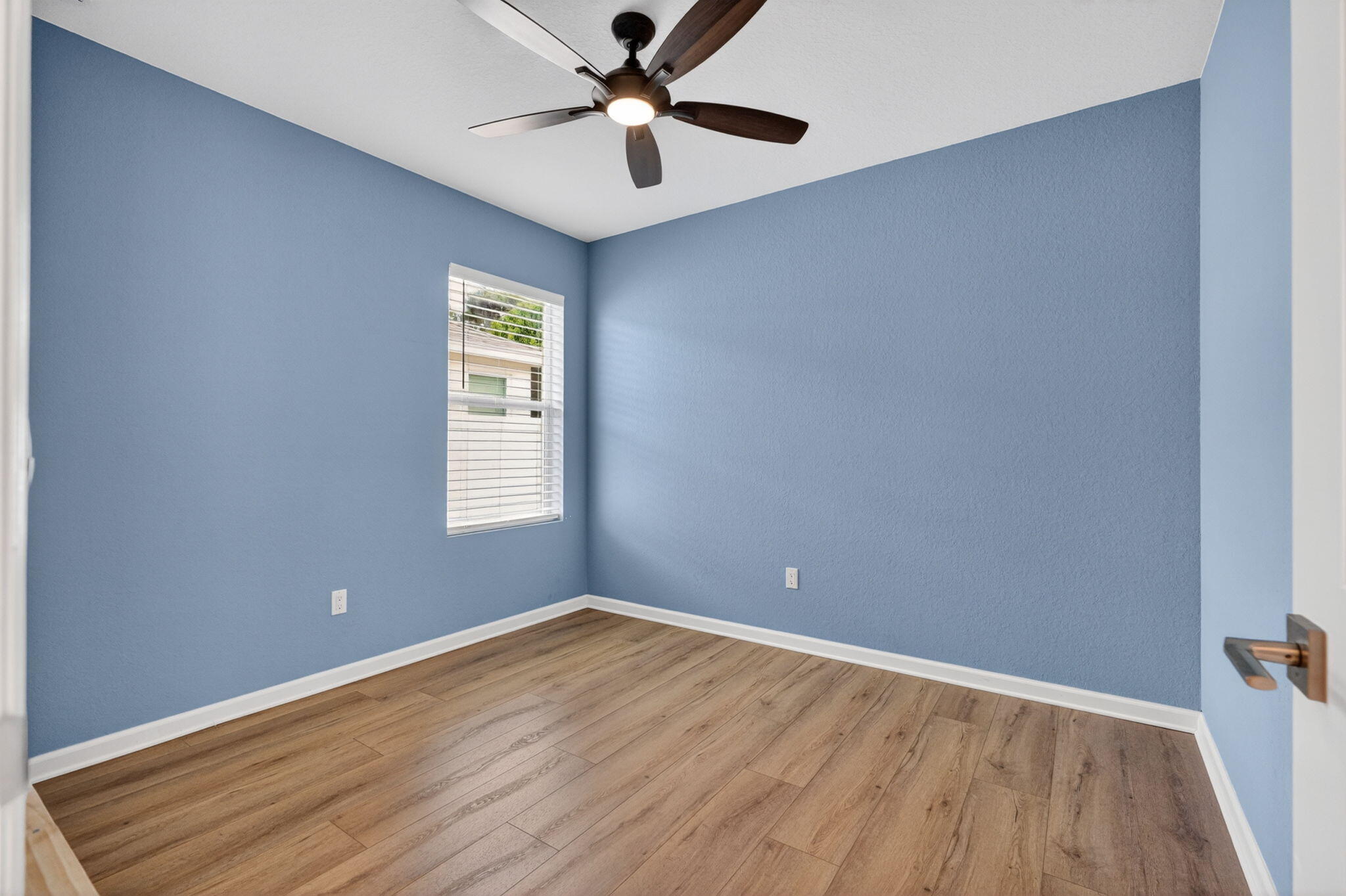 6814 Mitchell Street Jupiter, FL 33458 - Photo 12 of 49 wooden floor in an empty room with a window