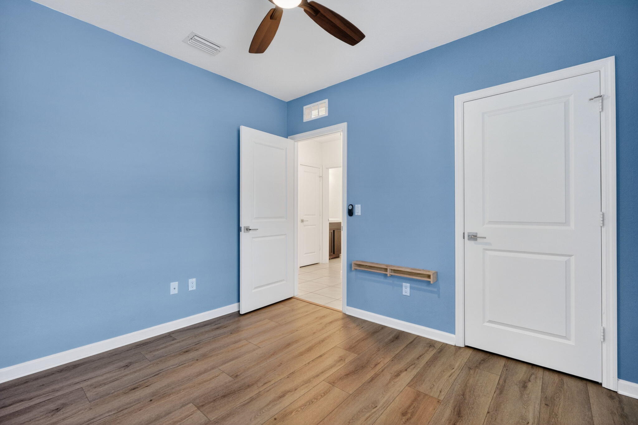 6814 Mitchell Street Jupiter, FL 33458 - Photo 13 of 49 an empty room with wooden floor and windows