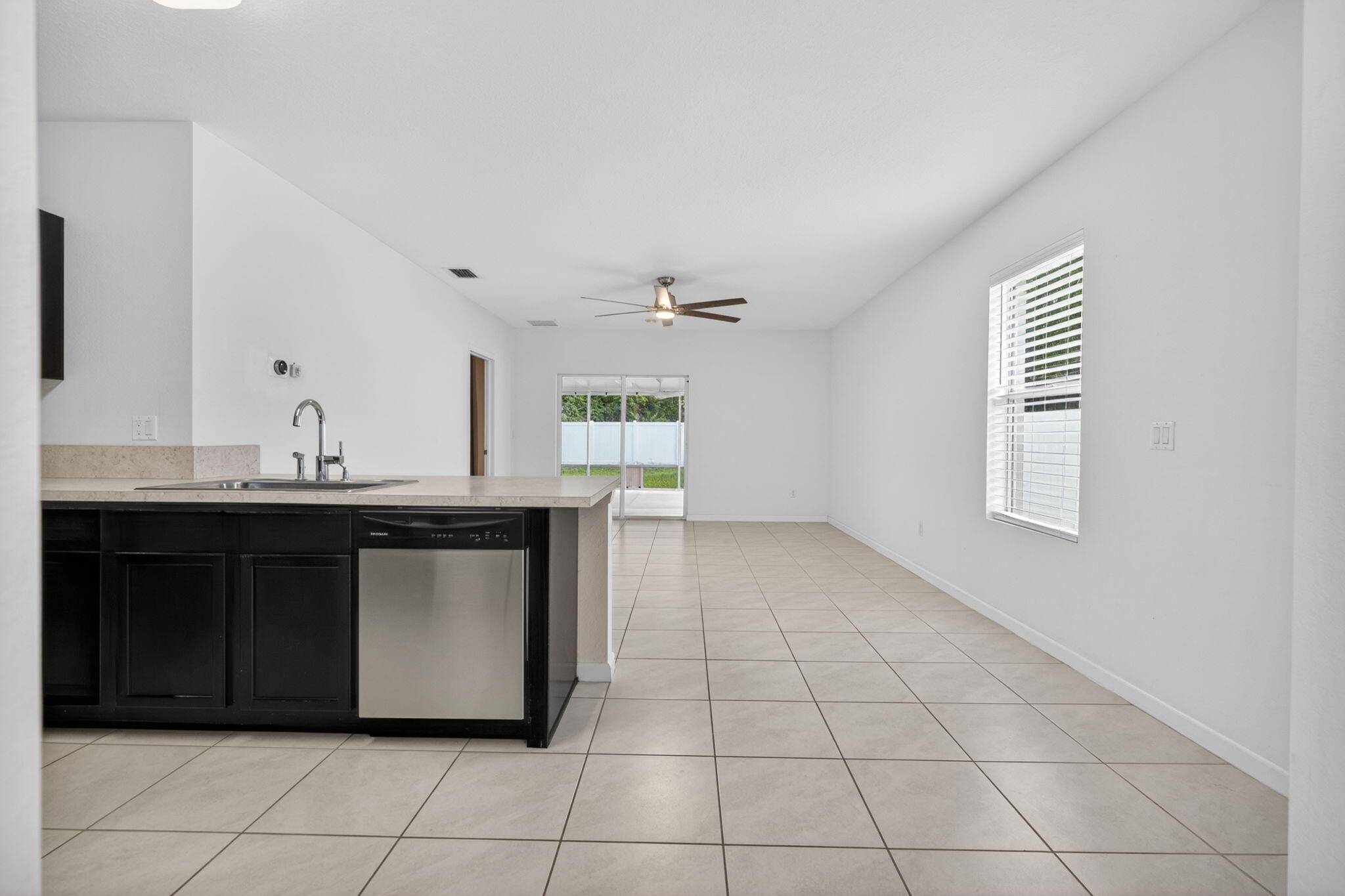 6814 Mitchell Street Jupiter, FL 33458 - Photo 14 of 49 a kitchen with a sink cabinets and window