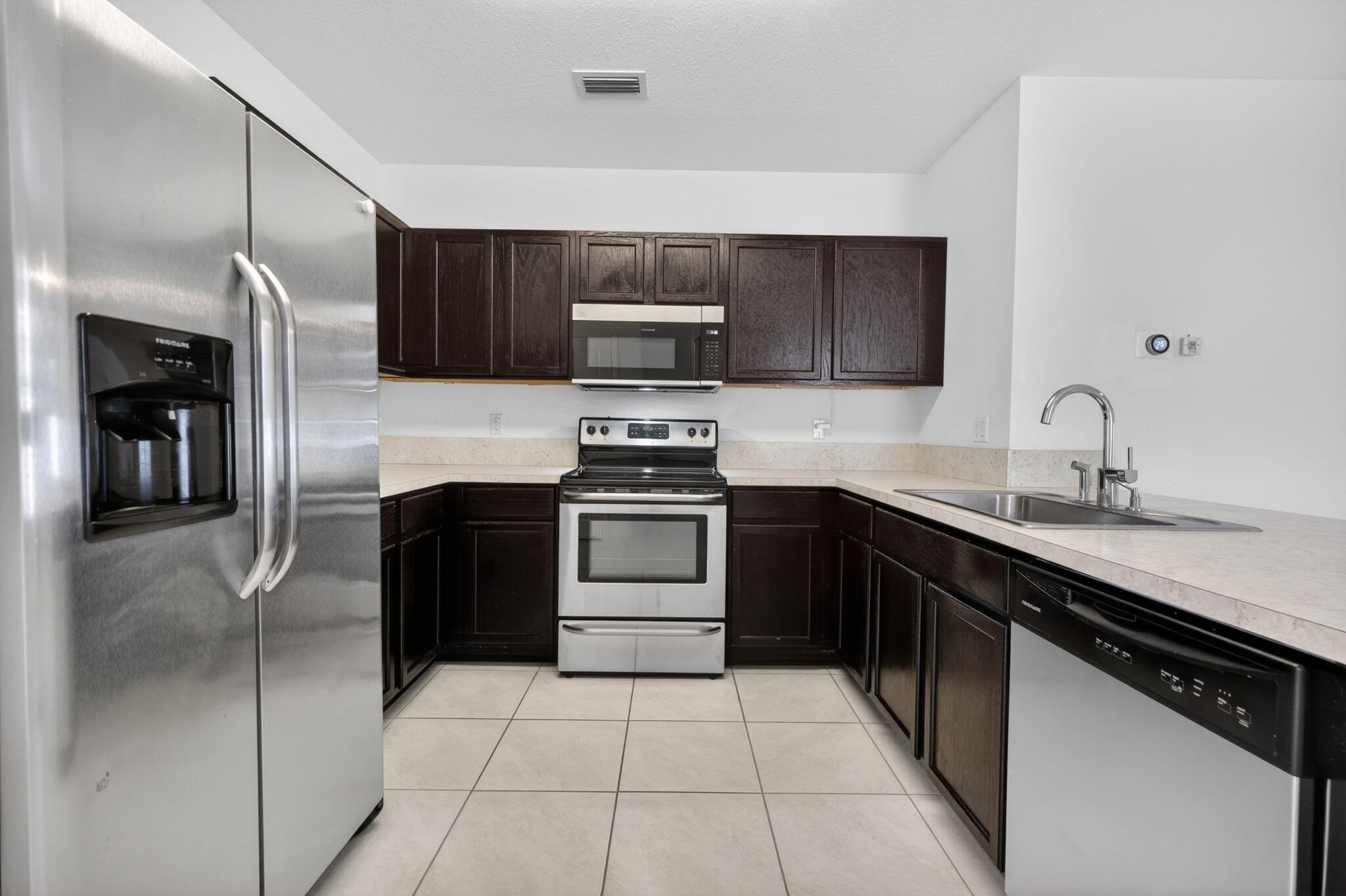 6814 Mitchell Street Jupiter, FL 33458 - Photo 16 of 49 a kitchen with a sink and stainless steel appliances