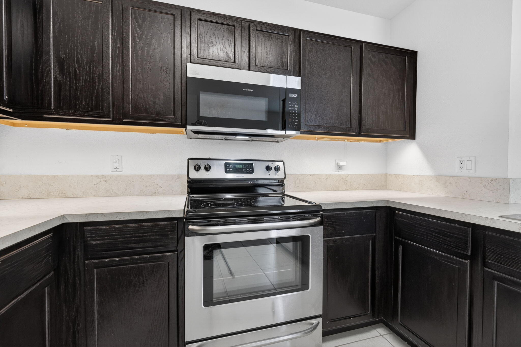 6814 Mitchell Street Jupiter, FL 33458 - Photo 20 of 49 a kitchen with granite countertop wood cabinets and stainless steel appliances