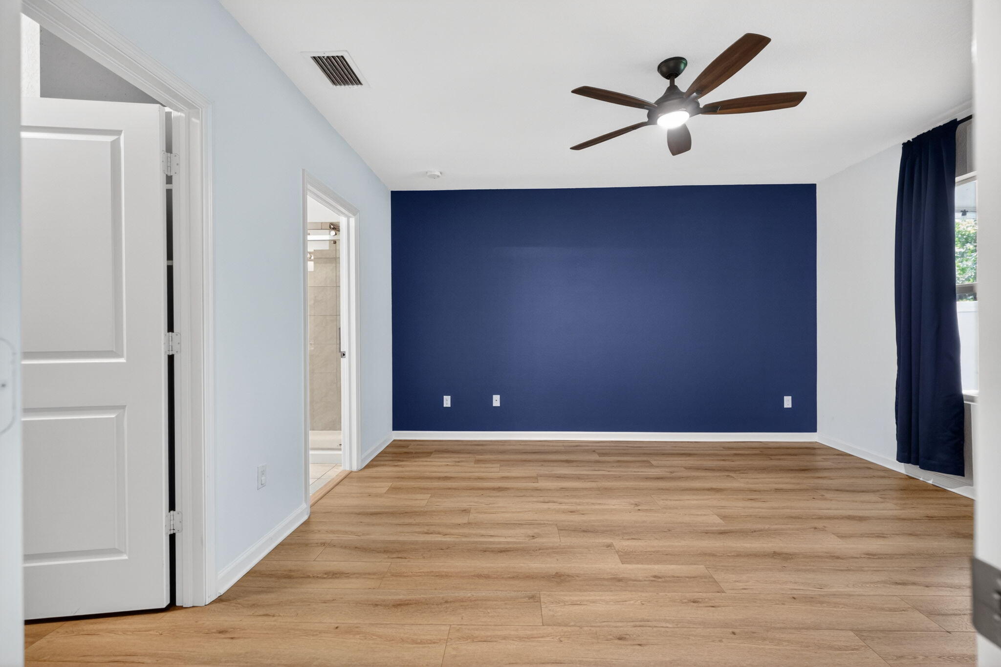 6814 Mitchell Street Jupiter, FL 33458 - Photo 26 of 49 a view of a livingroom with a ceiling fan and wooden floor