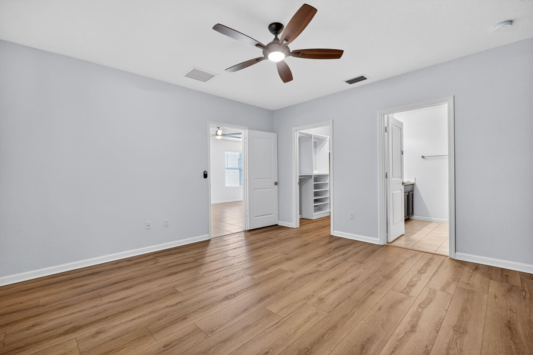 6814 Mitchell Street Jupiter, FL 33458 - Photo 30 of 49 an empty room with closet and a ceiling fan
