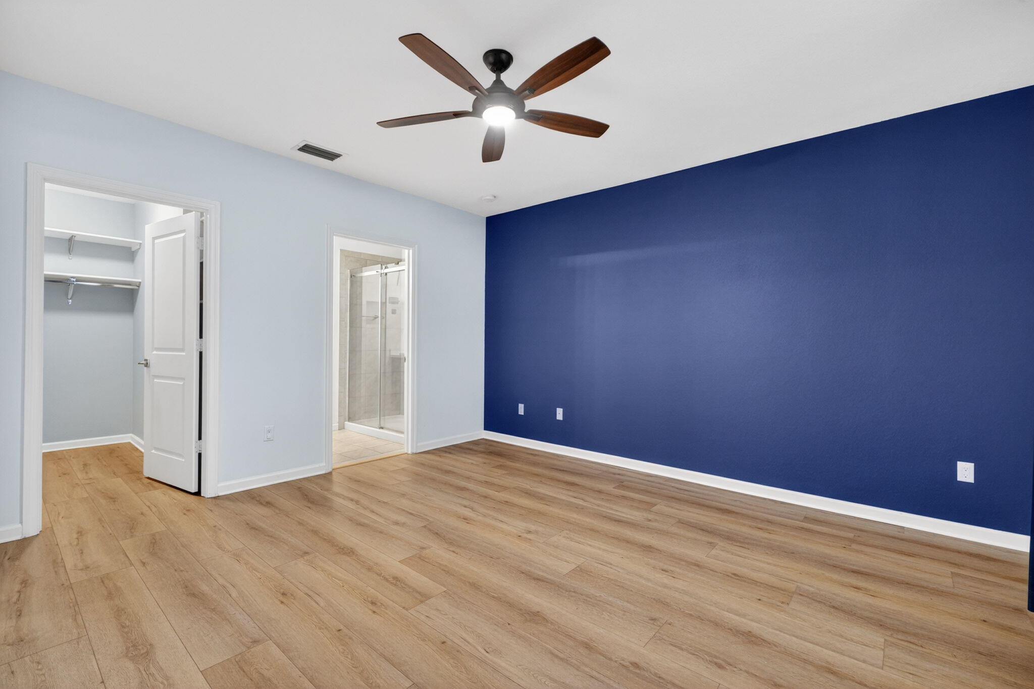 6814 Mitchell Street Jupiter, FL 33458 - Photo 32 of 49 an empty room with wooden floor and a ceiling fan