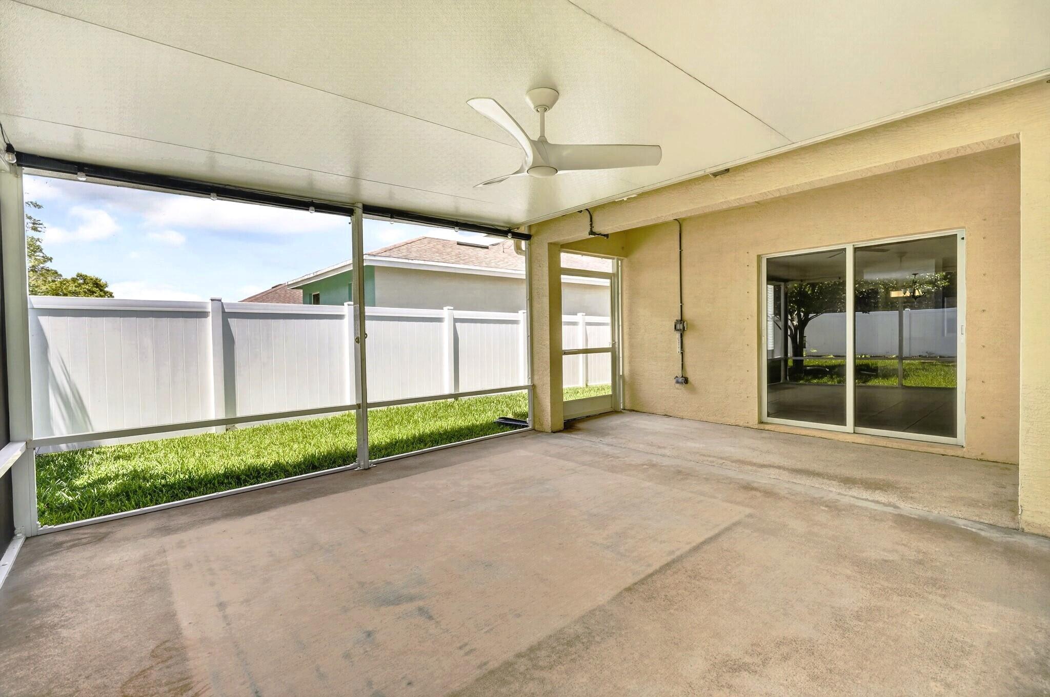 6814 Mitchell Street Jupiter, FL 33458 - Photo 38 of 49 a view of a house with a yard and garage