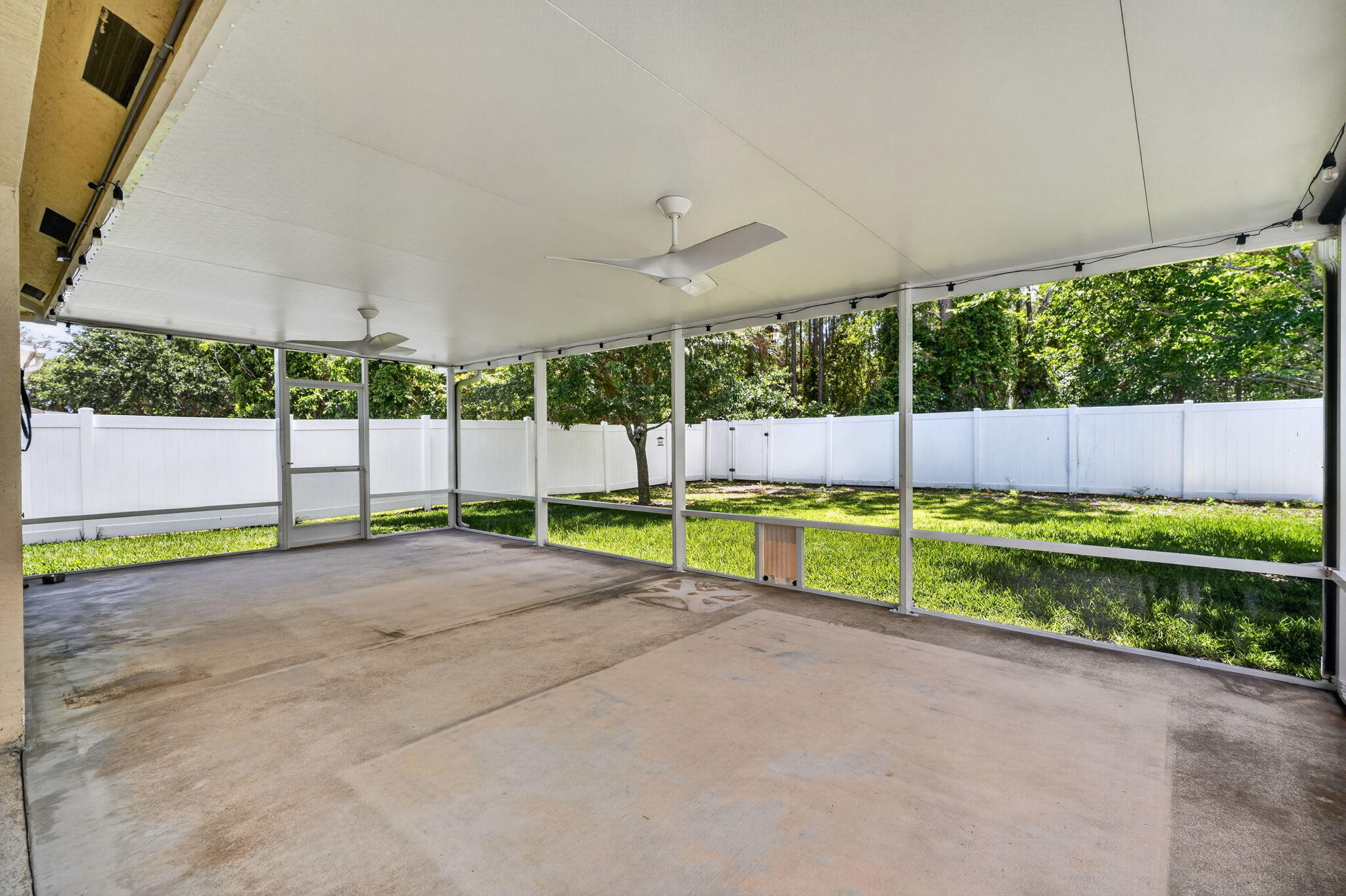 6814 Mitchell Street Jupiter, FL 33458 - Photo 40 of 49 a view of a backyard with grass and a fence