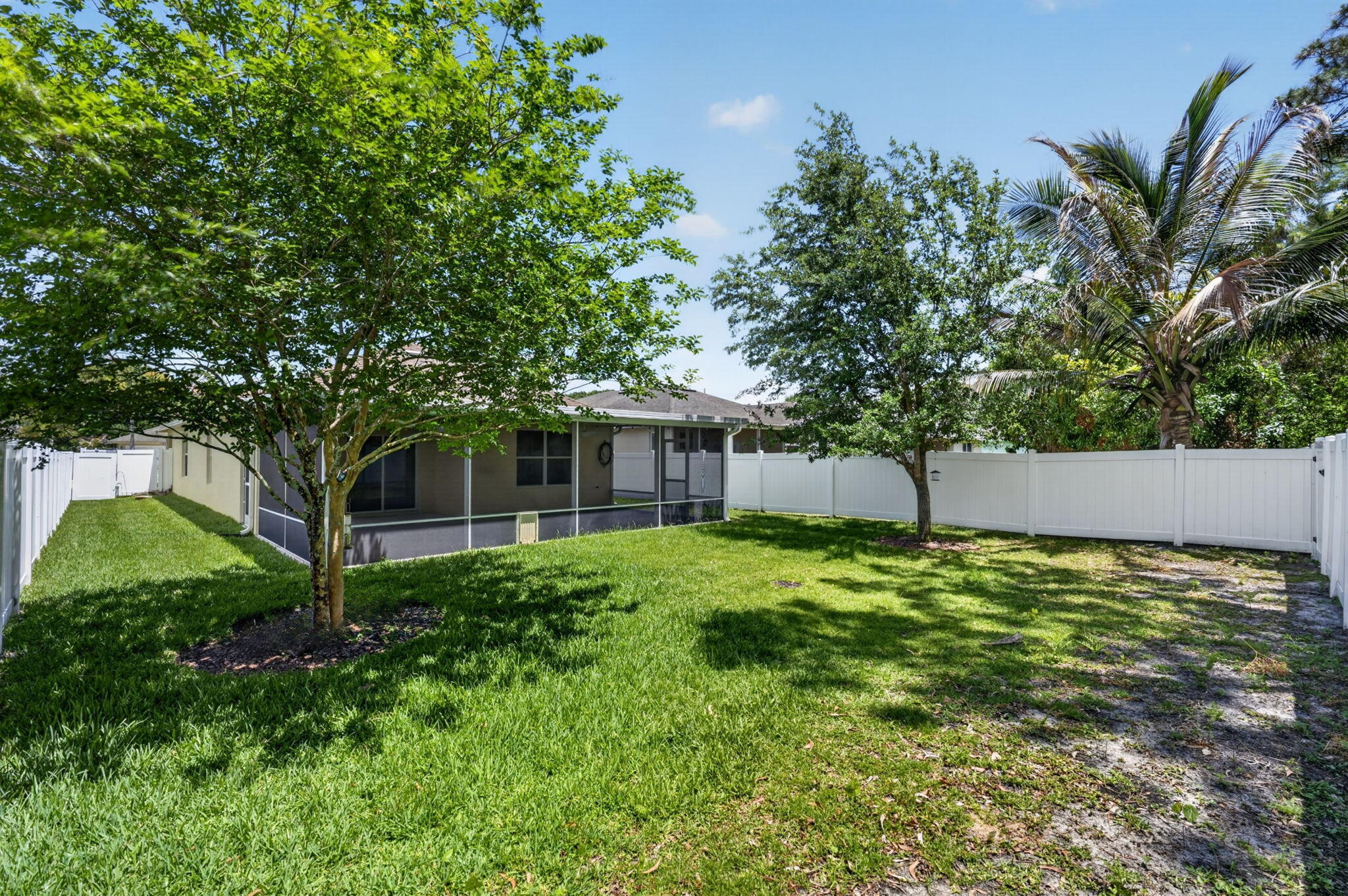 6814 Mitchell Street Jupiter, FL 33458 - Photo 42 of 49 a backyard of a house with lots of green space