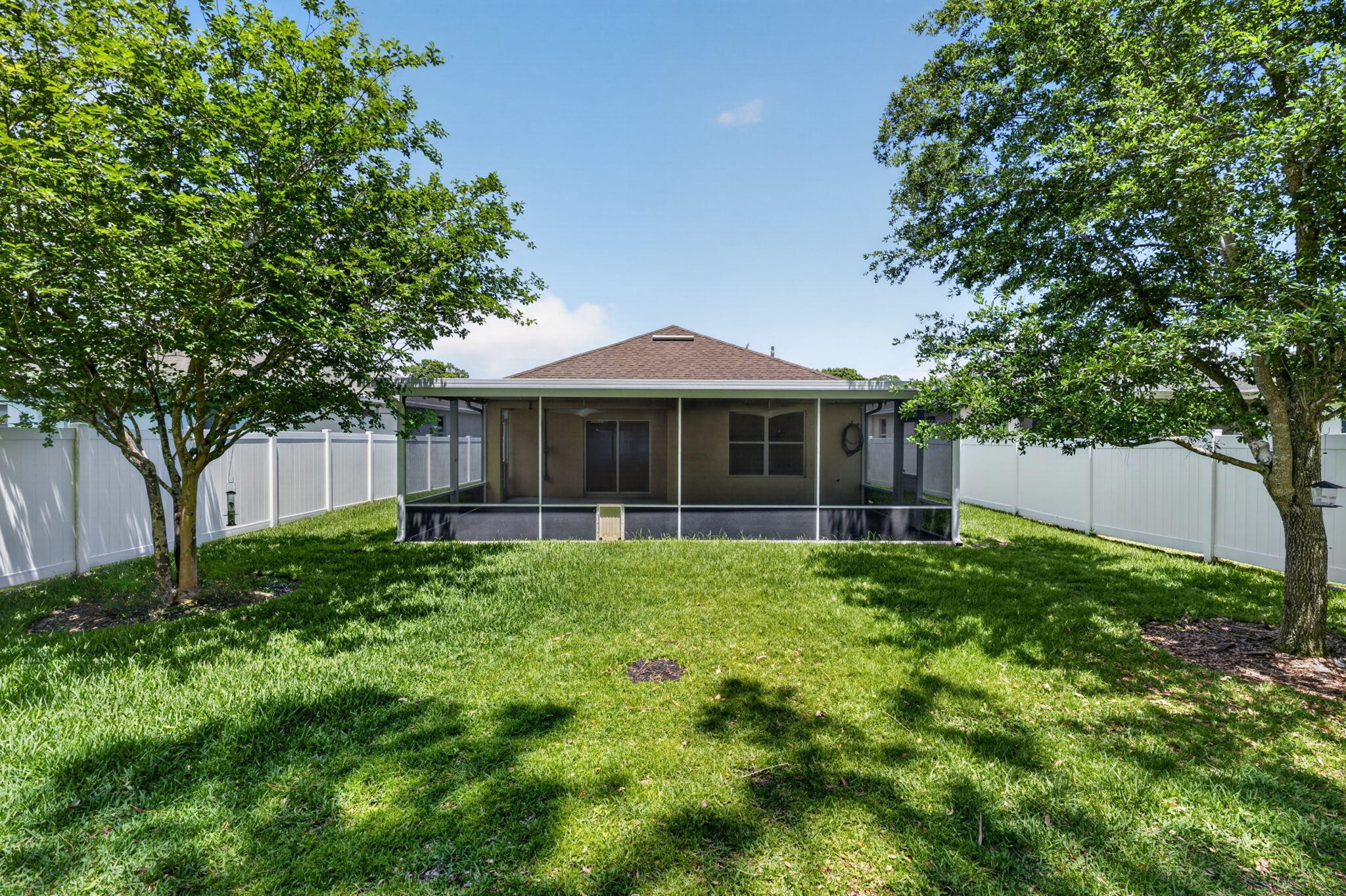 6814 Mitchell Street Jupiter, FL 33458 - Photo 43 of 49 a front view of a house with a yard and trees