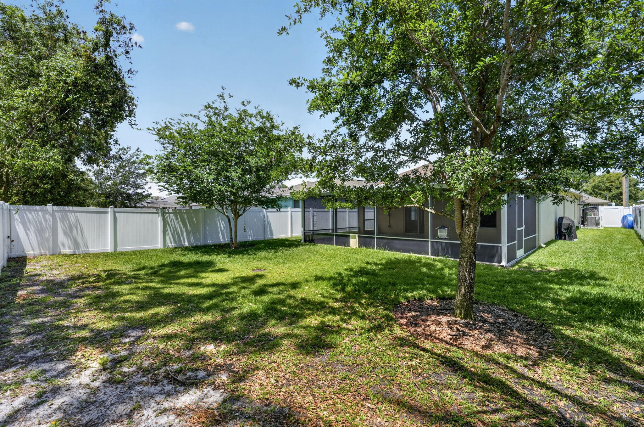 6814 Mitchell Street Jupiter, FL 33458 - Photo 44 of 49 a backyard of a house with lots of green space