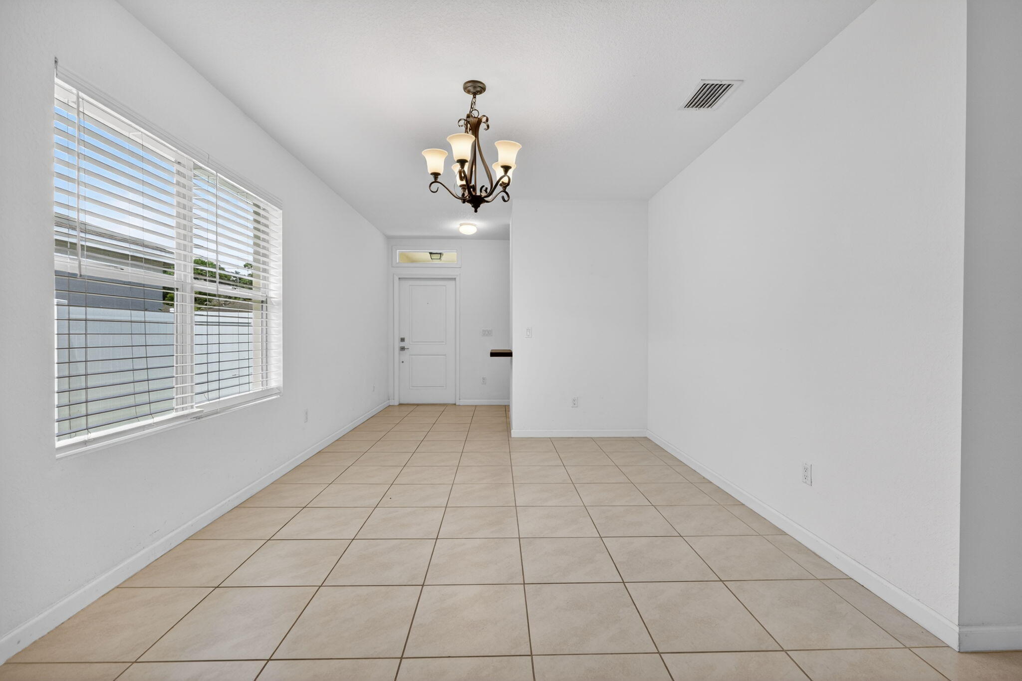 6814 Mitchell Street Jupiter, FL 33458 - Photo 5 of 49 a view of an empty room with a window