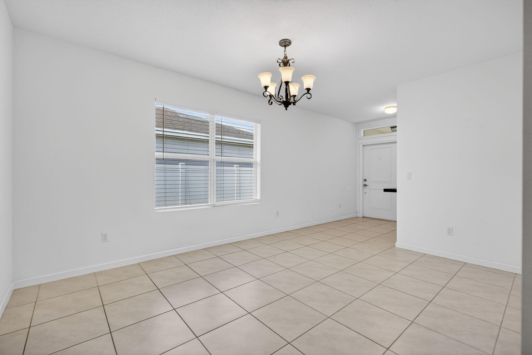 6814 Mitchell Street Jupiter, FL 33458 - Photo 6 of 49 a view of an empty room with a window