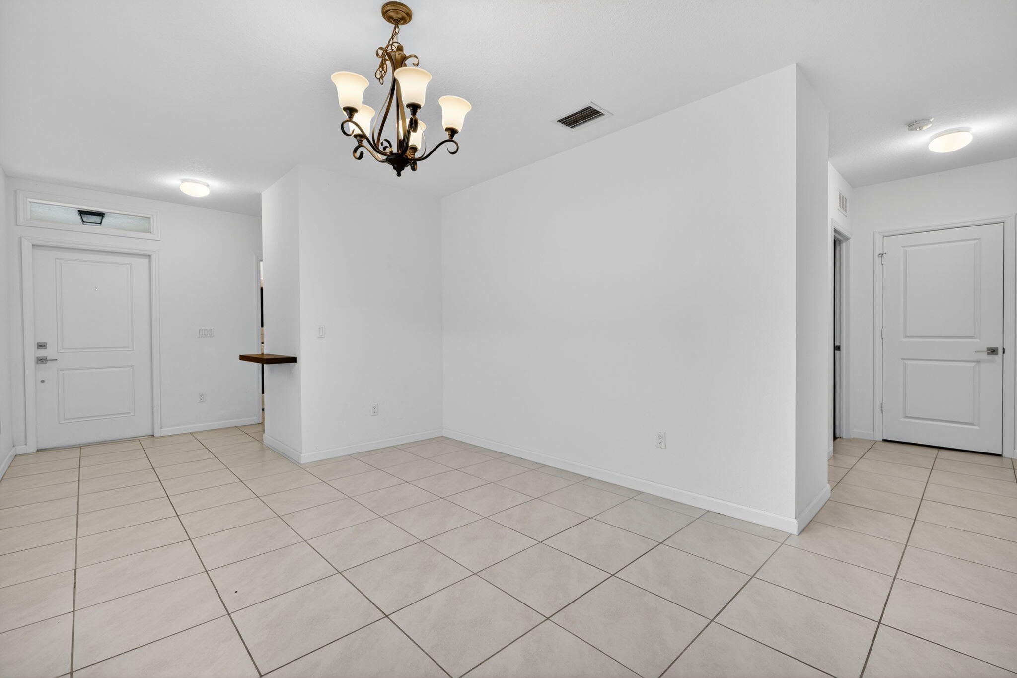 6814 Mitchell Street Jupiter, FL 33458 - Photo 8 of 49 an empty room with kitchen view