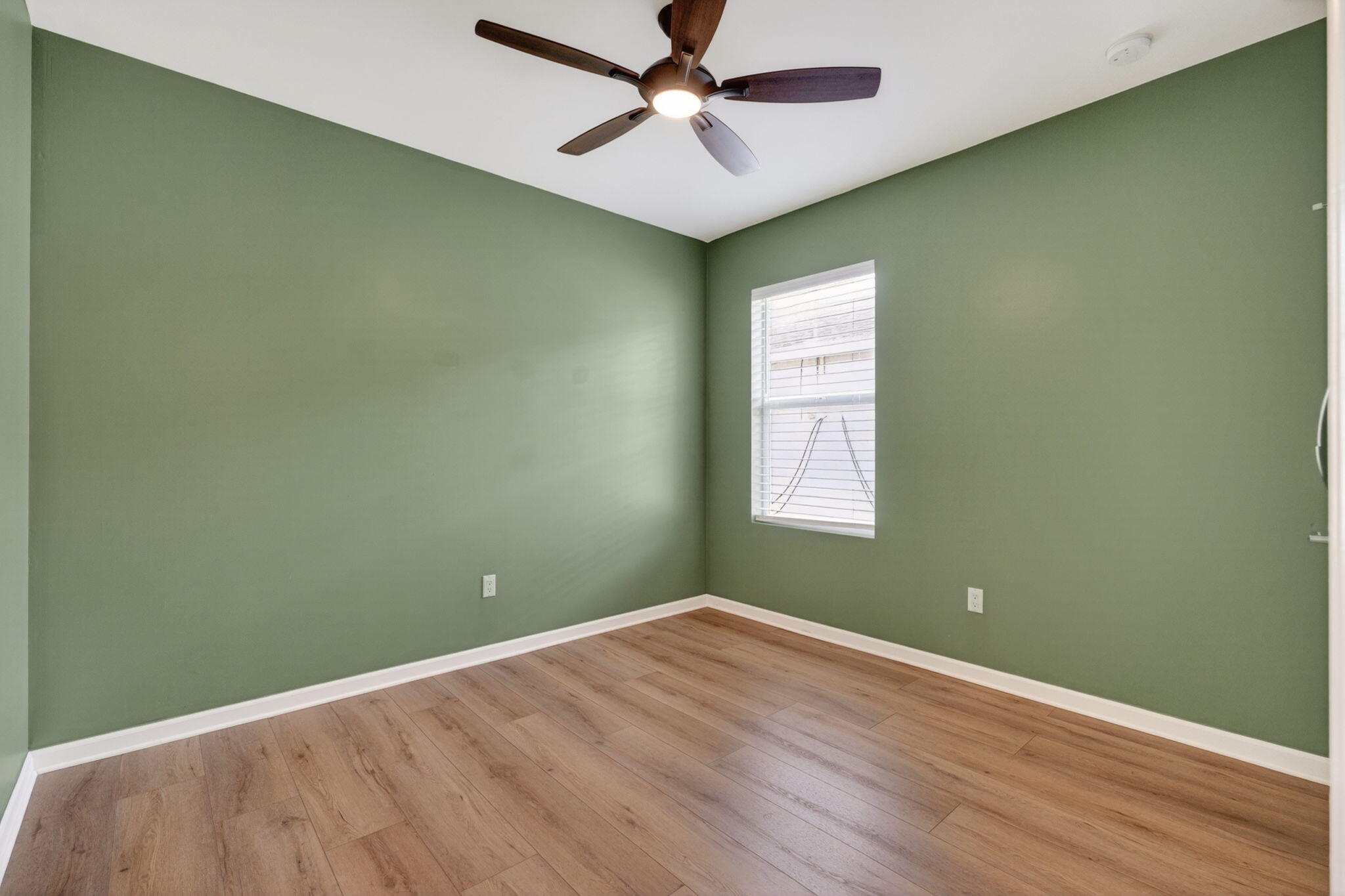 6814 Mitchell Street Jupiter, FL 33458 - Photo 9 of 49 an empty room with a window and ceiling fan