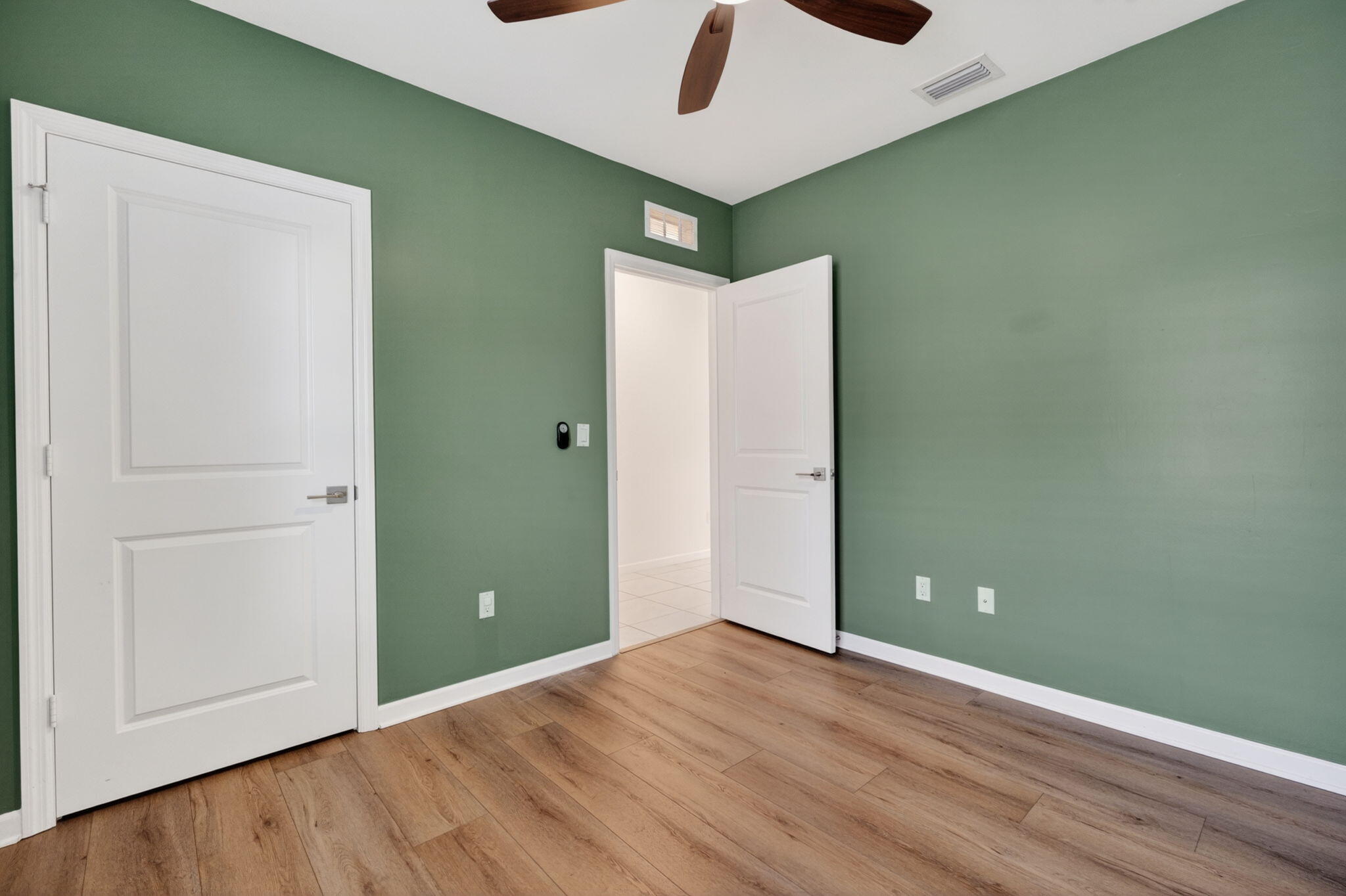 6814 Mitchell Street Jupiter, FL 33458 - Photo 10 of 49 an empty room with wooden floor closet and windows