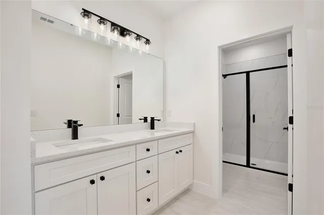 a bathroom with a double vanity sink and mirror