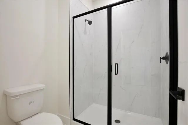 a bathroom with a shower and a toilet