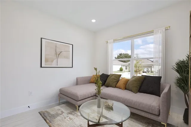 a living room with furniture and a large window