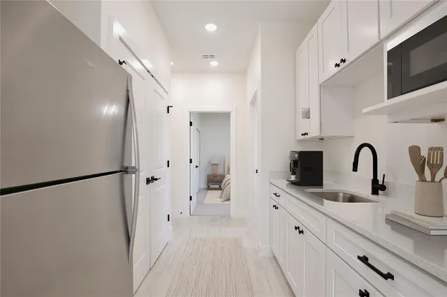 a spacious bathroom with a double vanity sink a mirror and shower