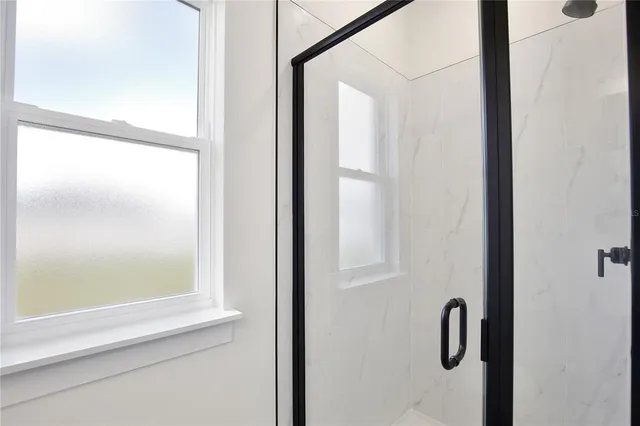a bathroom with a glass shower door