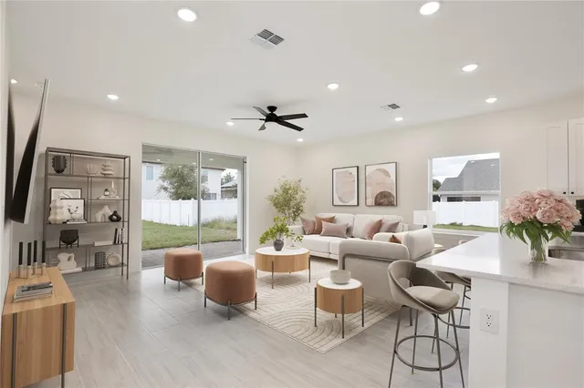 a living room with furniture and a large window