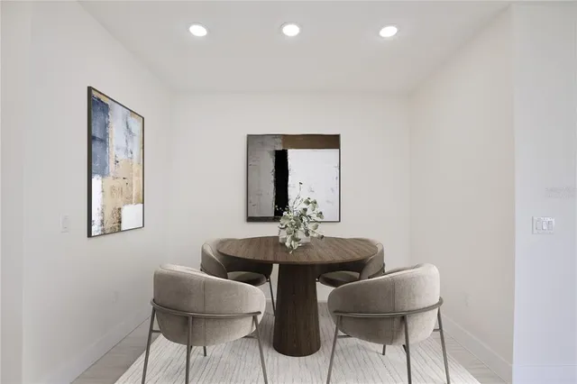 a dining room with furniture and a potted plant