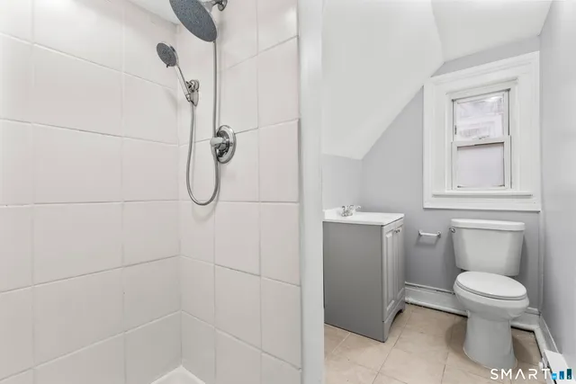 a bathroom with a toilet and a shower