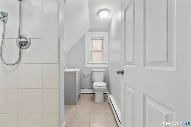a white toilet sitting next to a bathroom sink