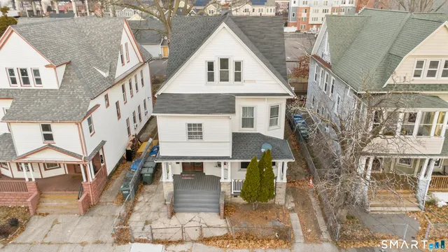 a view of residential houses with wooden fence