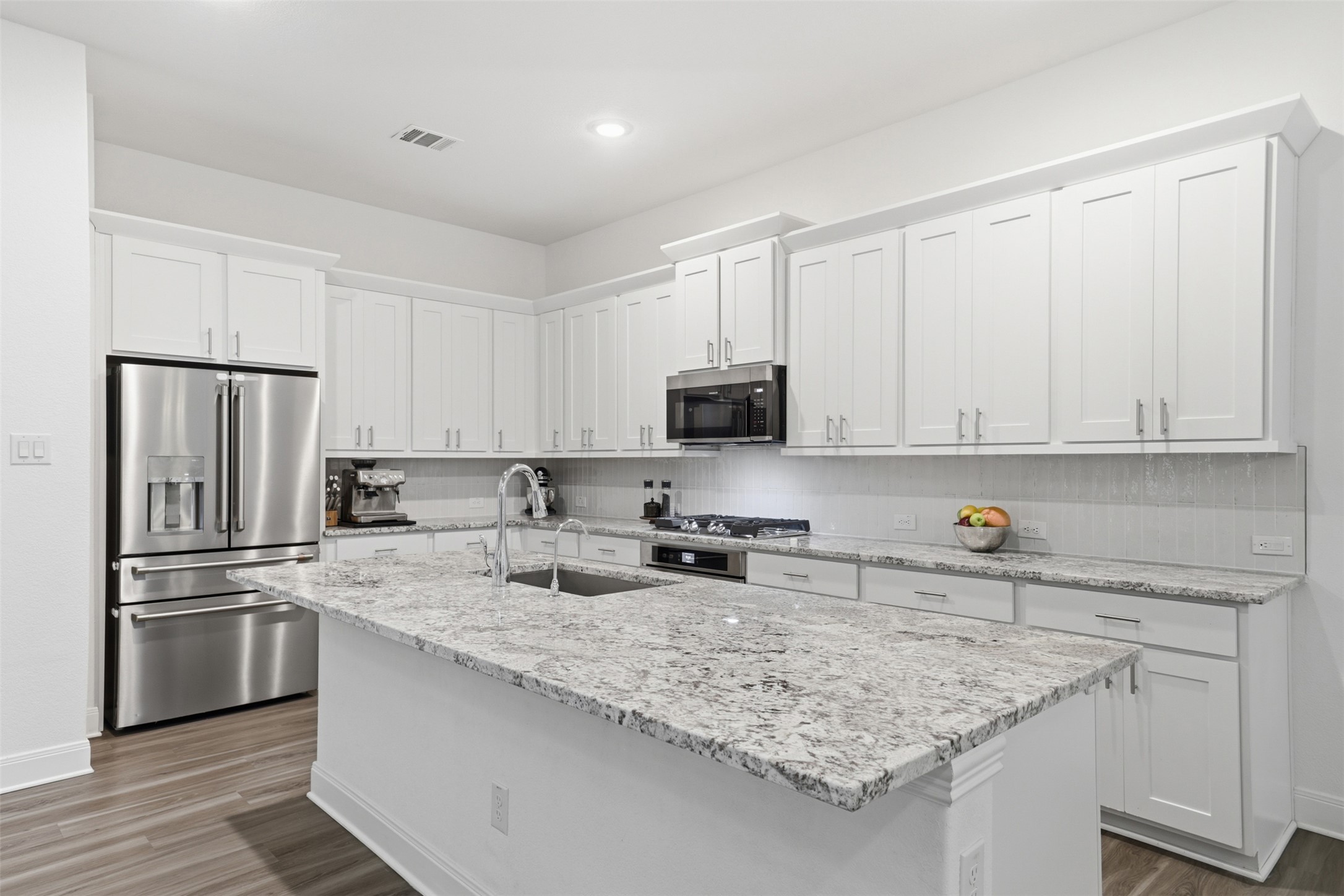 3021 Sage Ranch Drive Leander, TX 78641 - Photo 11 of 32 a kitchen with stainless steel appliances granite countertop a sink stove and refrigerator