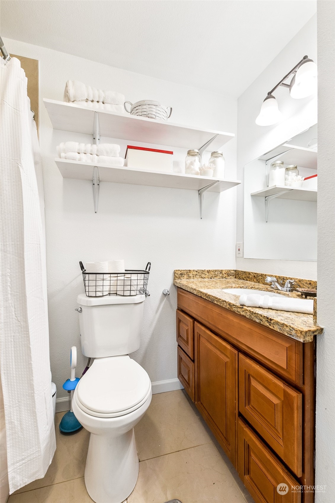 1031 Southwest 118th Street Seattle, WA 98146 - Photo 11 of 16 a bathroom with a stove and cabinets
