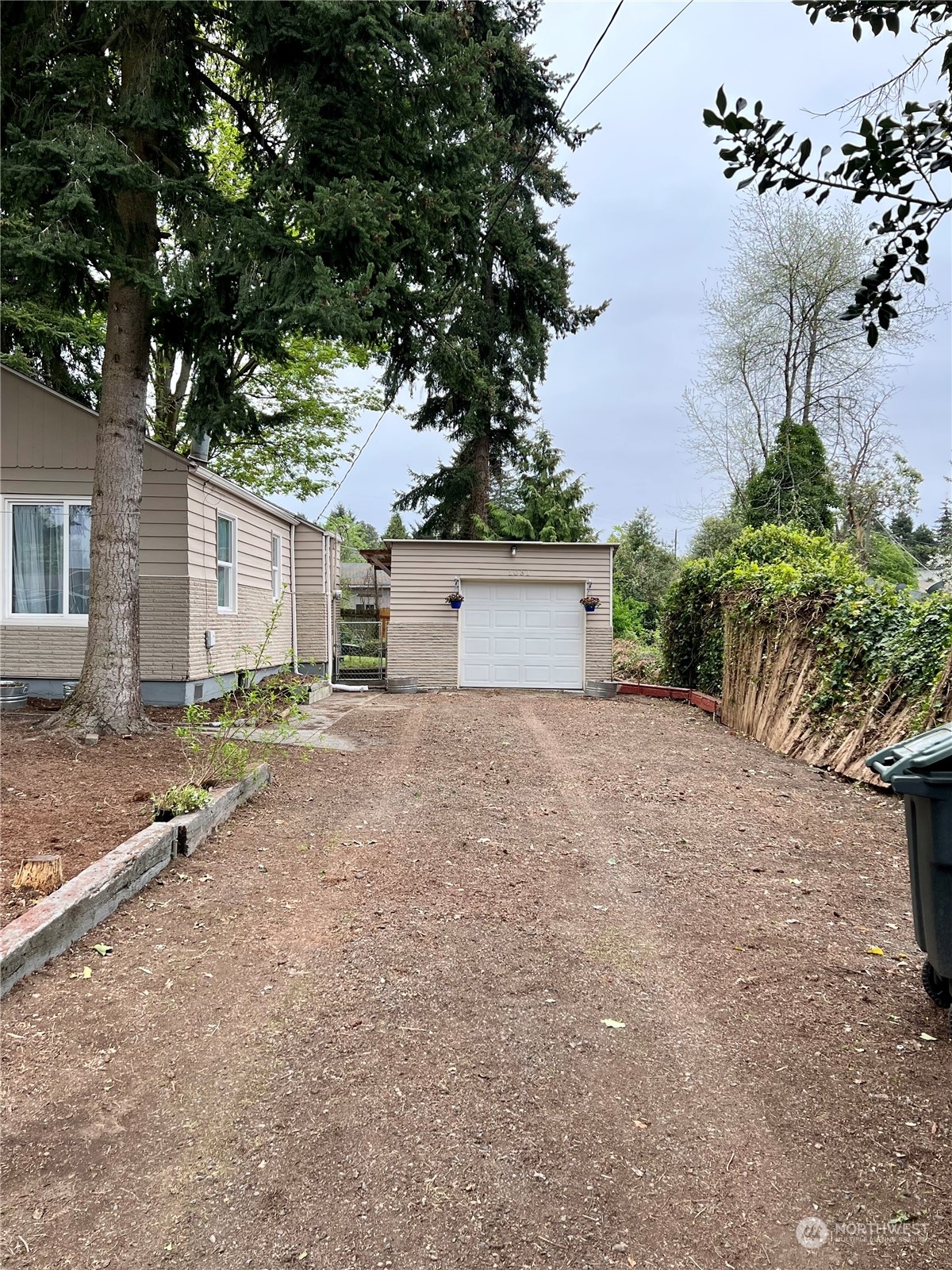 1031 Southwest 118th Street Seattle, WA 98146 - Photo 13 of 16 front view of a house with a yard and a tree