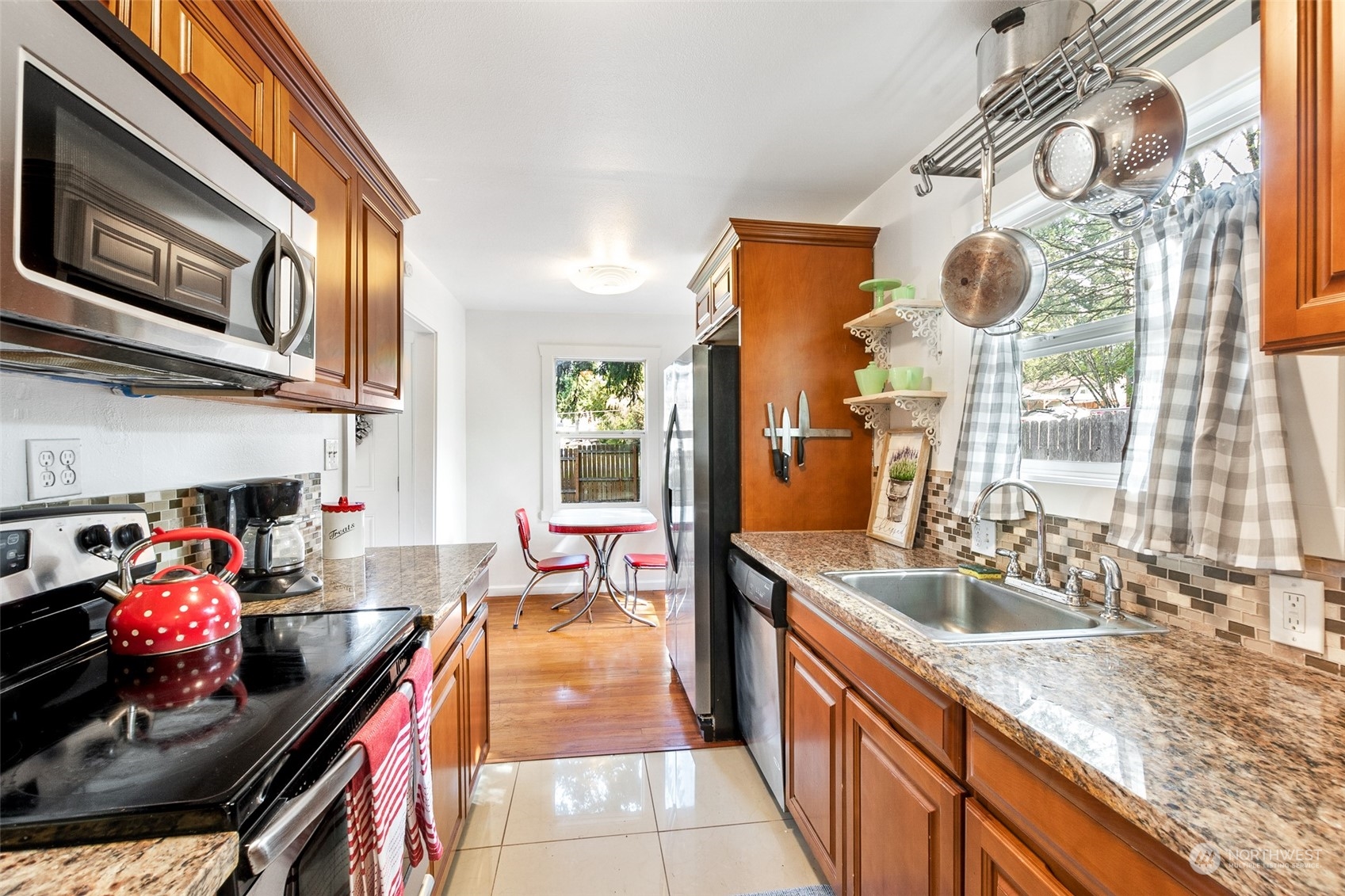 1031 Southwest 118th Street Seattle, WA 98146 - Photo 6 of 16 a kitchen with stainless steel appliances granite countertop a sink stove and cabinets