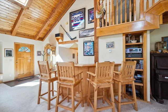 a view of a dining room with furniture and chandelier