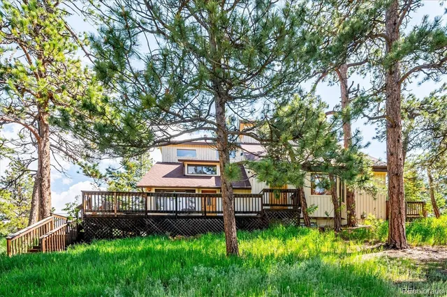 a backyard of a house with lots of green space and fountain