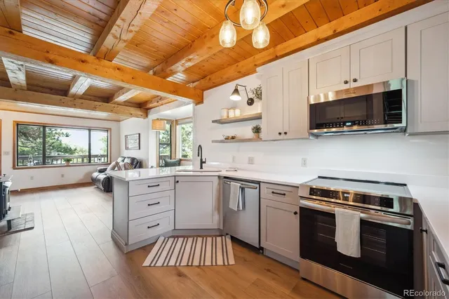 a kitchen with stainless steel appliances a stove sink and microwave