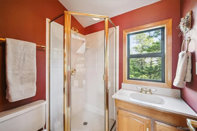 a bathroom with a granite countertop sink and a large mirror