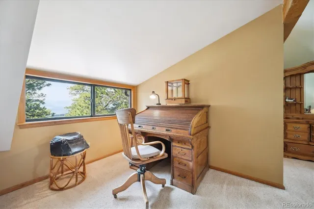 a spacious bedroom with a bed a couch and a flat screen tv