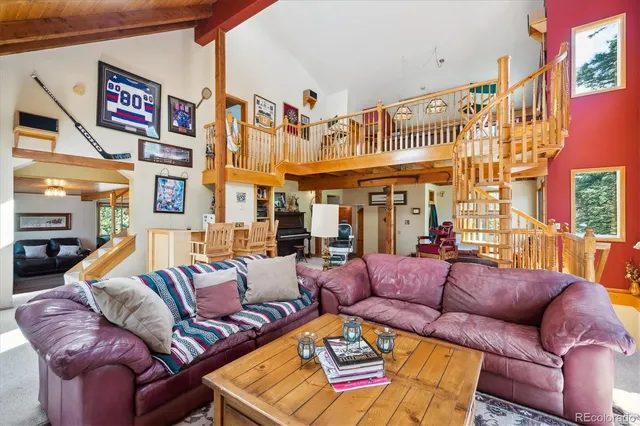 a view of a patio with couches and a potted plant on a city street