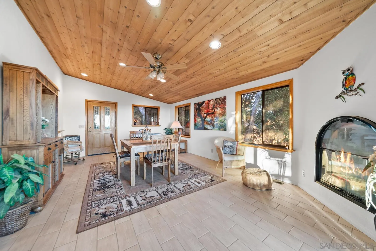 4641 Luneta View Julian, CA 92036 - Photo 29 of 56 a dining room with furniture a floor to ceiling window and potted plants