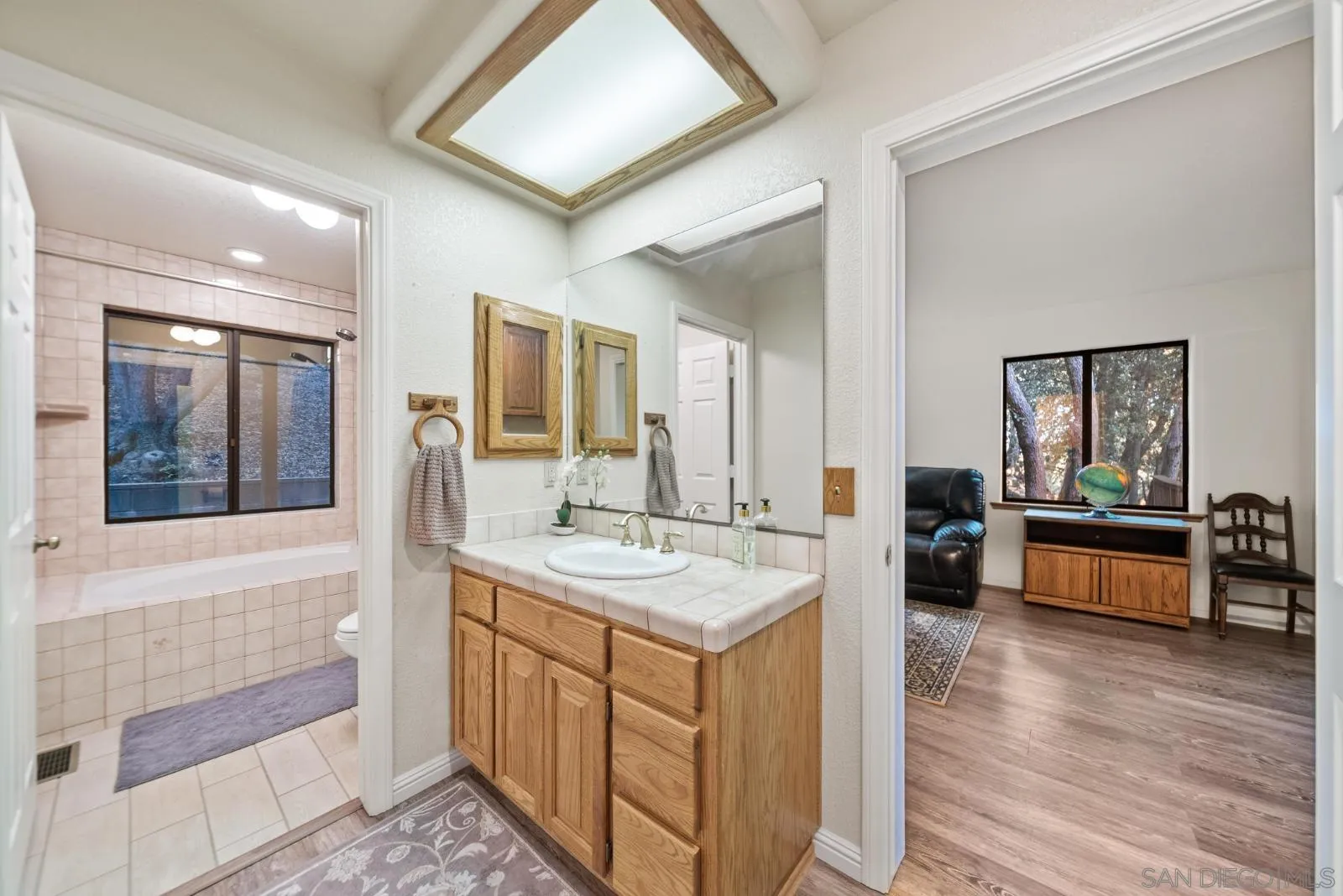 4641 Luneta View Julian, CA 92036 - Photo 32 of 56 a spacious bathroom with a granite countertop sink mirror and bathtub