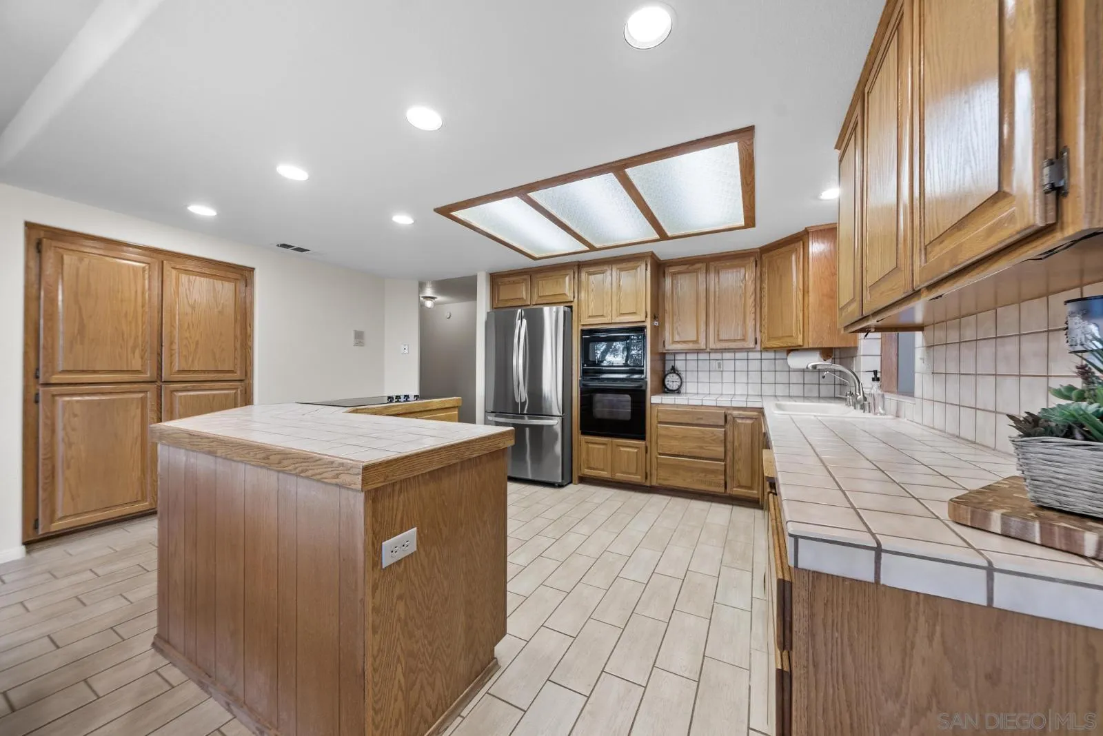 4641 Luneta View Julian, CA 92036 - Photo 5 of 56 a kitchen with stainless steel appliances granite countertop a refrigerator a sink dishwasher and a stove with wooden cabinets